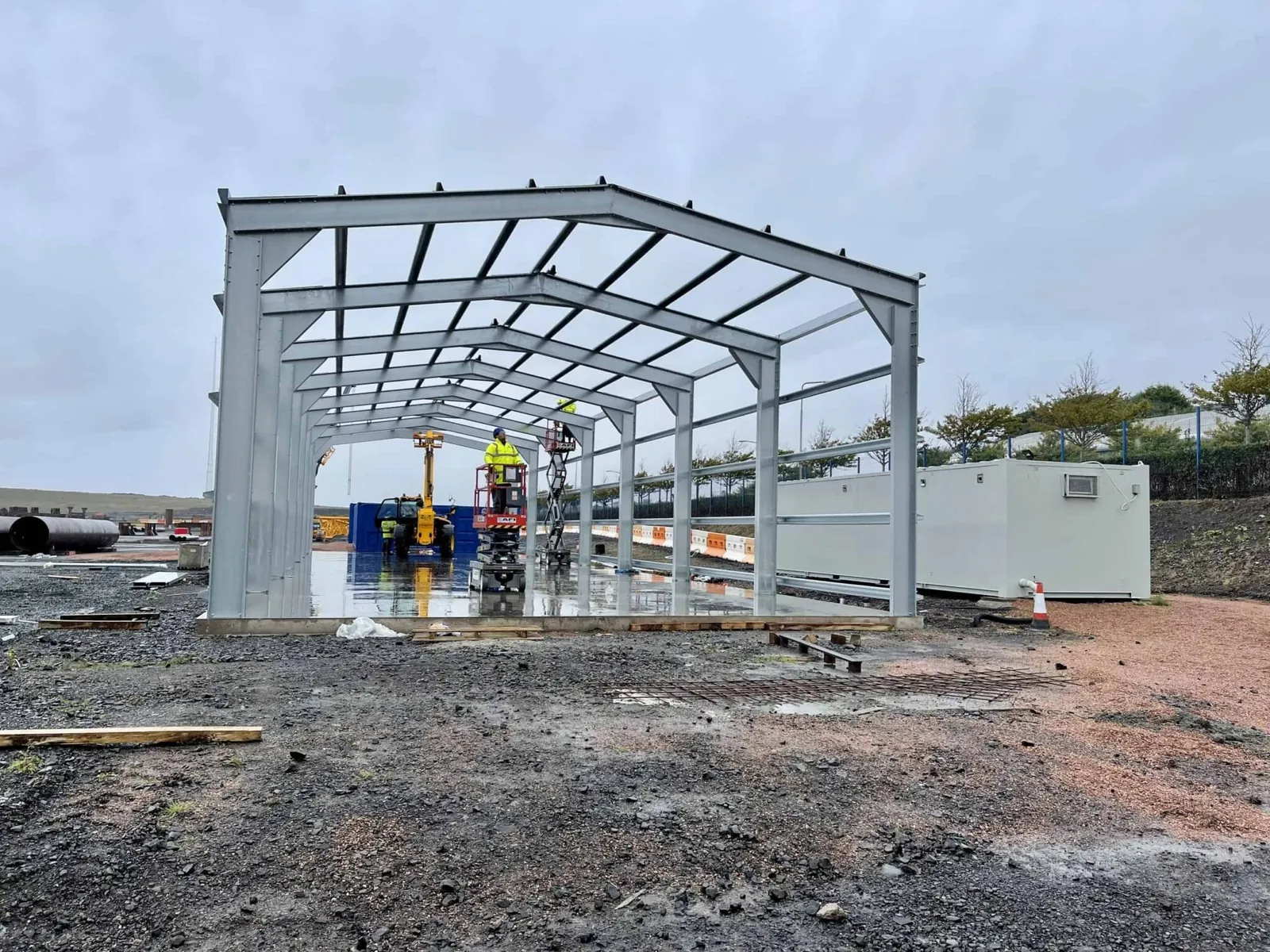 Galvanised portal frame going up on site before cladding
